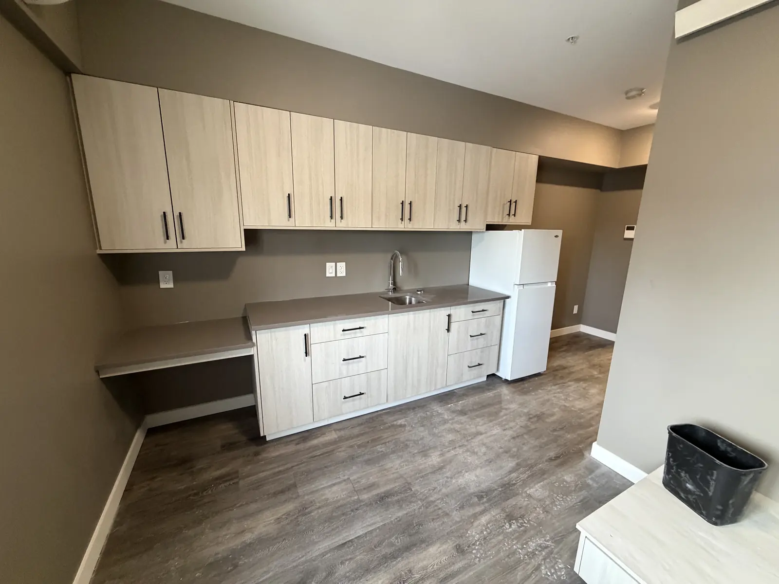 Kitchen with full-height cabinetry and built-in desk